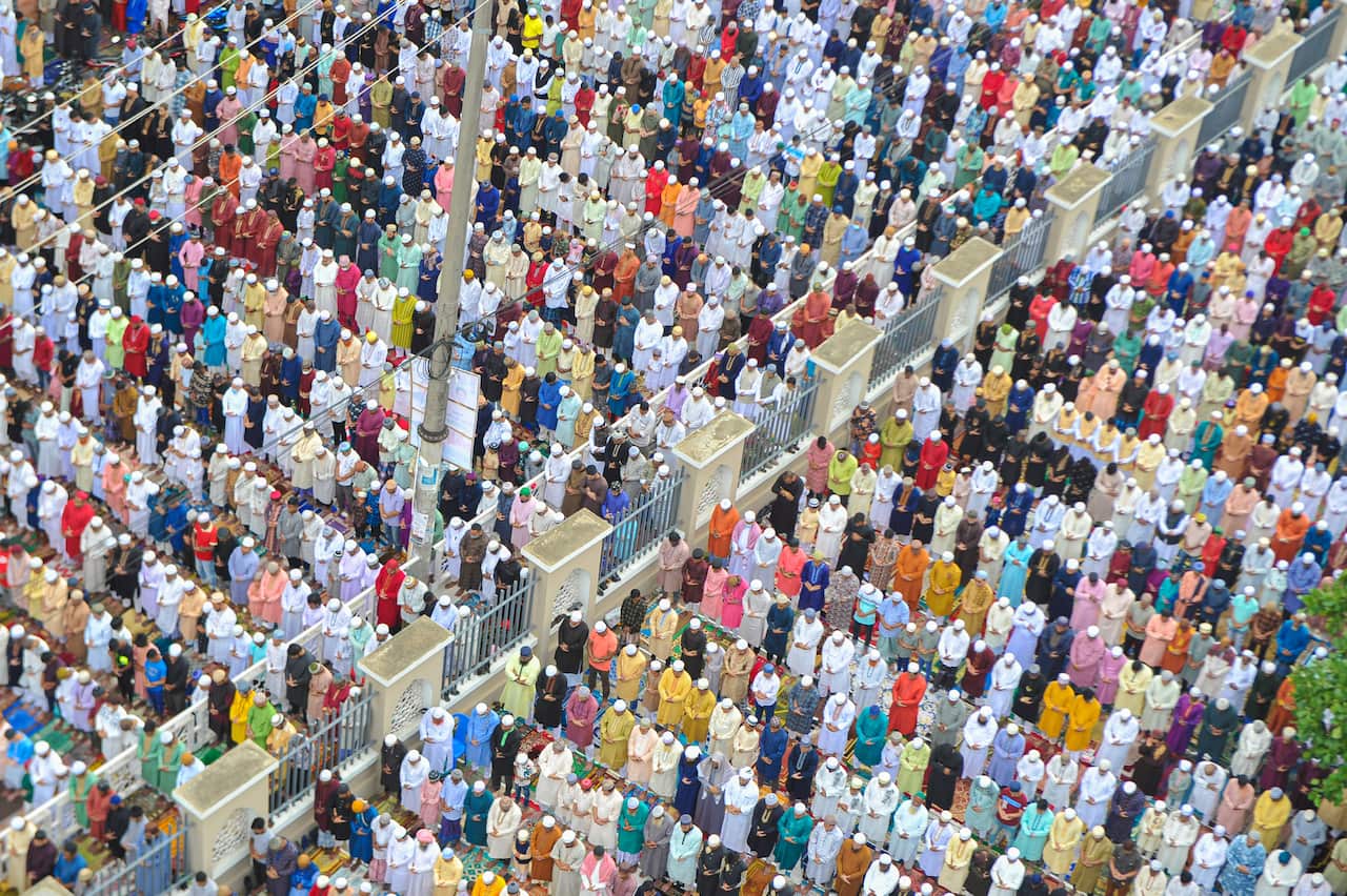 Aerial view of colourful Muslim worshippers praying.