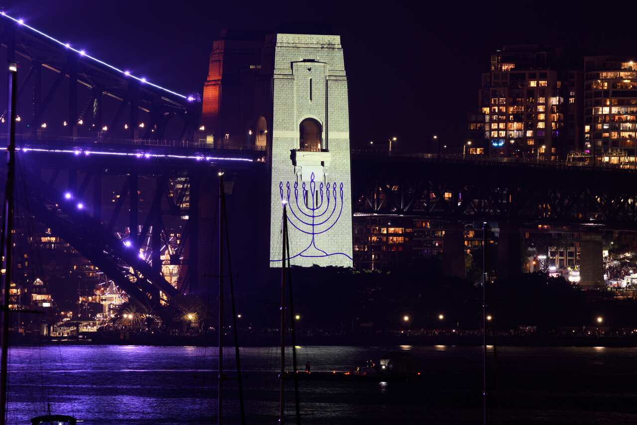 A menorah is projected onto the pylon of a bridge