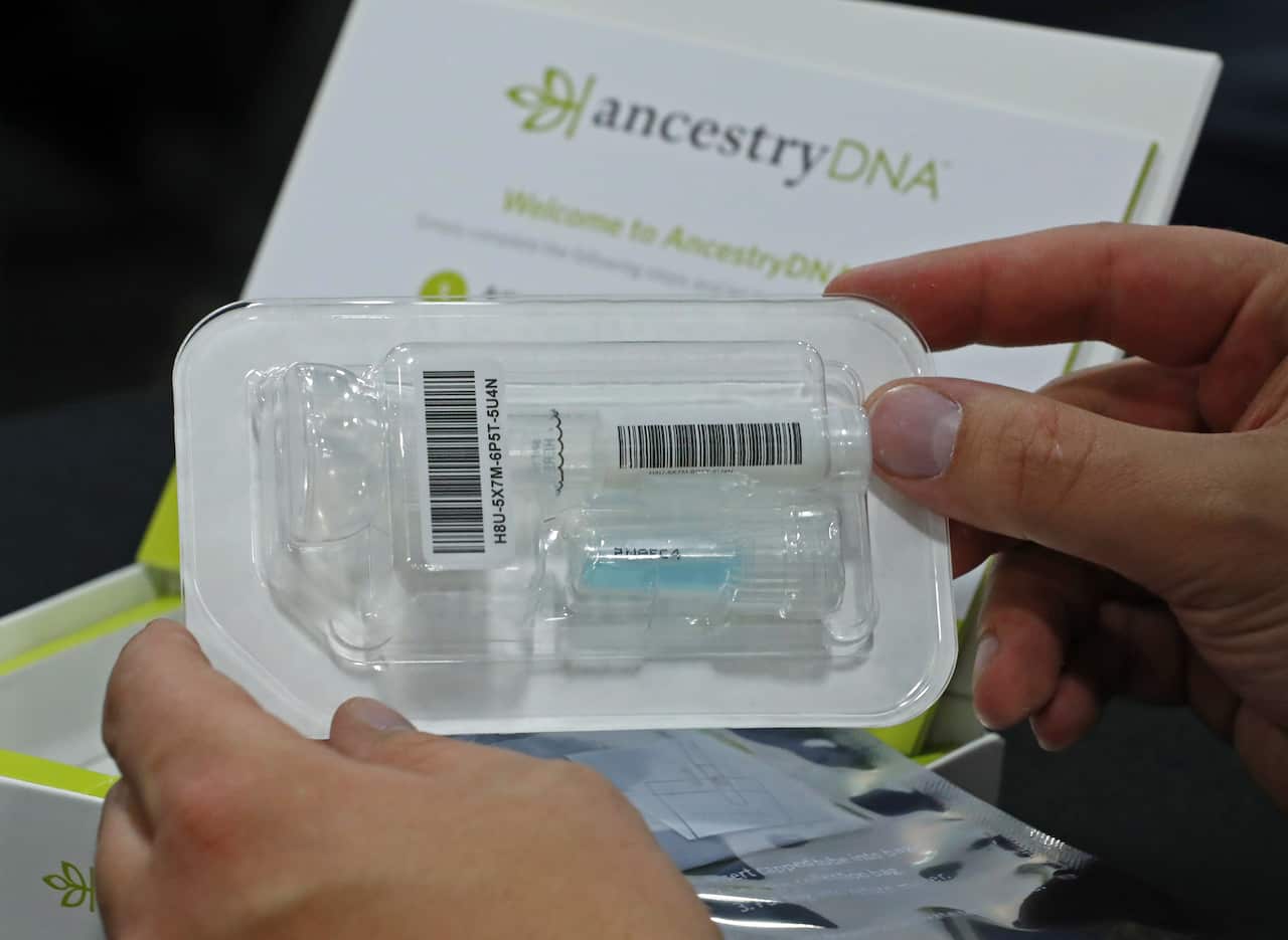 A person holding a DNA testing kit