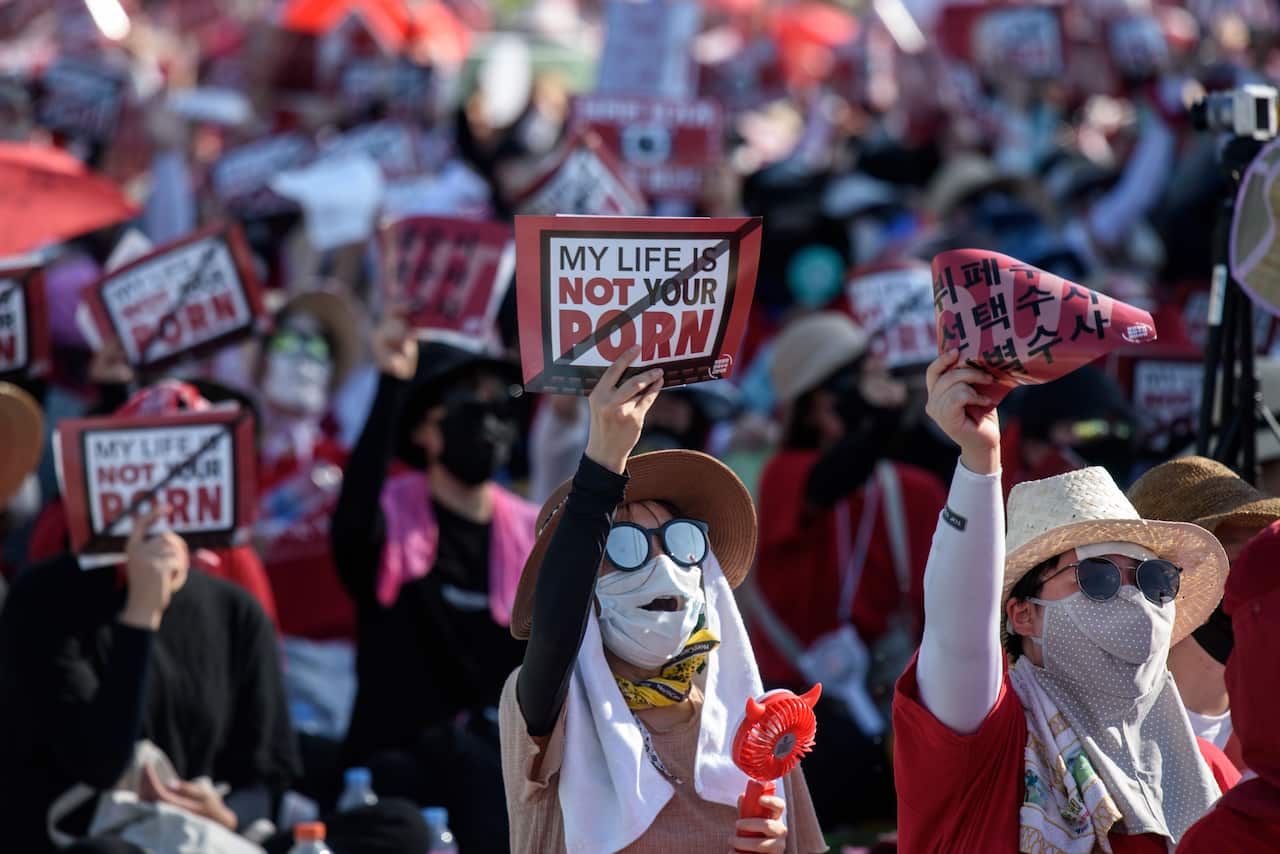 Masked female protestors. 