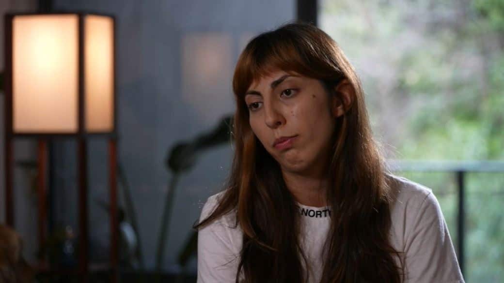 A woman speaking in an indoor interview setting.