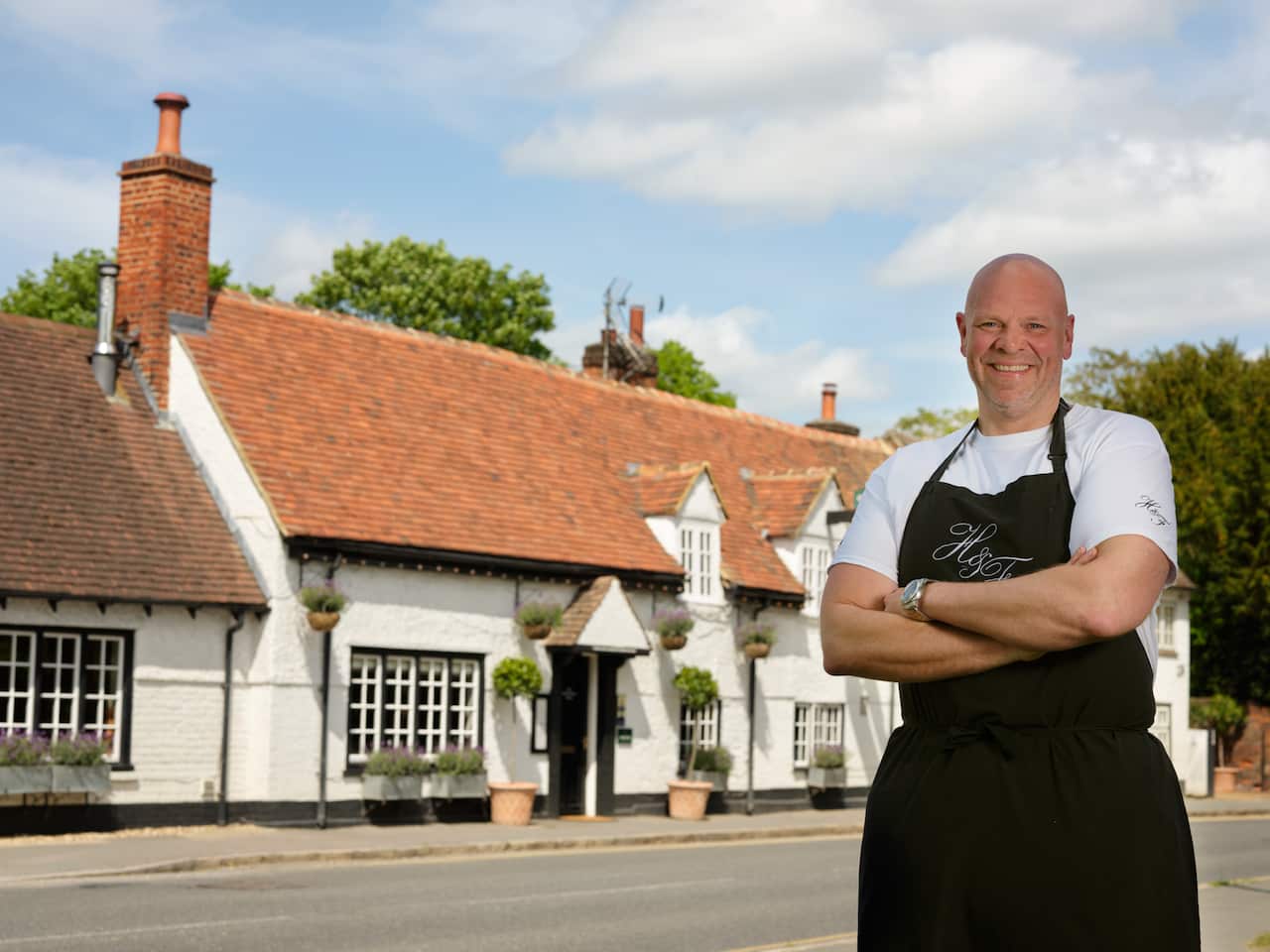 Tom Kerridge standing in front of his pub H&F