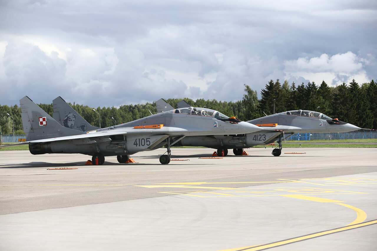 MiG-29 fighters jets are seen parked at an air base.