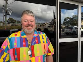 A man wearing a brightly coloured shirt