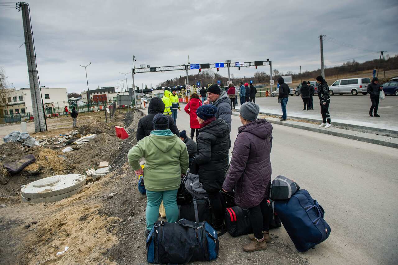 People wait for their relatives at the border crossing in Medyka, Poland.