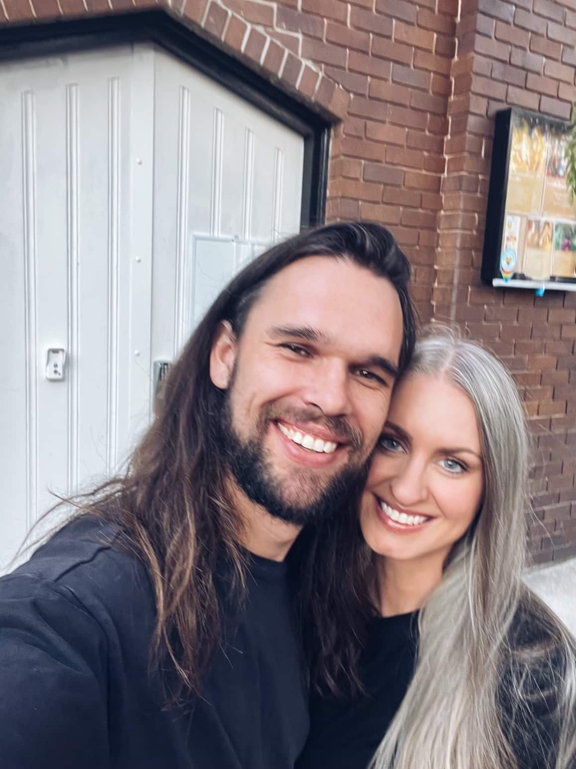 A selfie of a happy couple embracing.