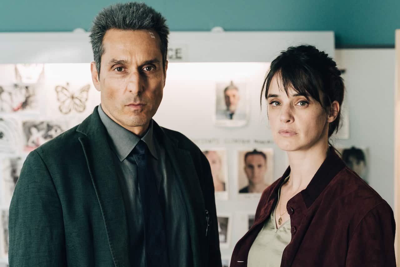 French actors Vincent Elbaz and Jennifer Decker stand side by side, posing for their crime show Syndrome E