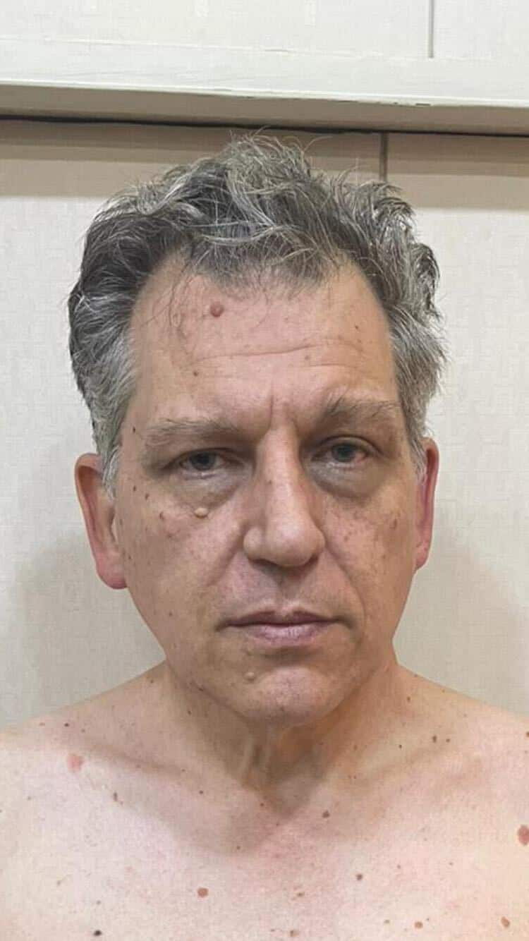 A man with a neutral facial expression.