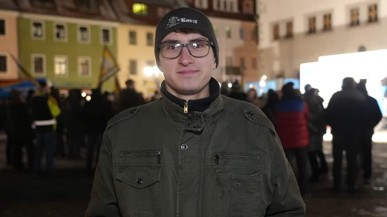 A young man with a beanie and glasses