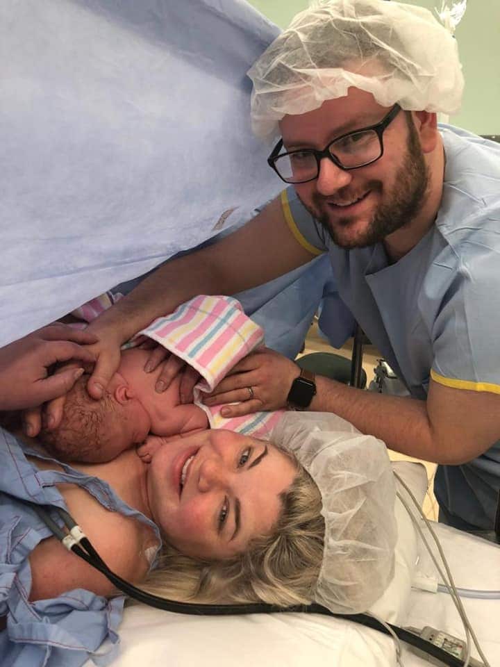 Rachel with her husband and newborn son on the day of his birth.
