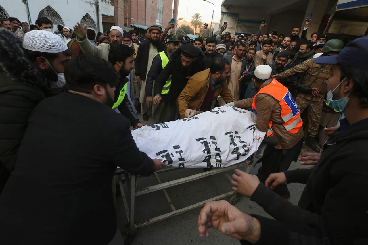 People carry body on a stretcher. 