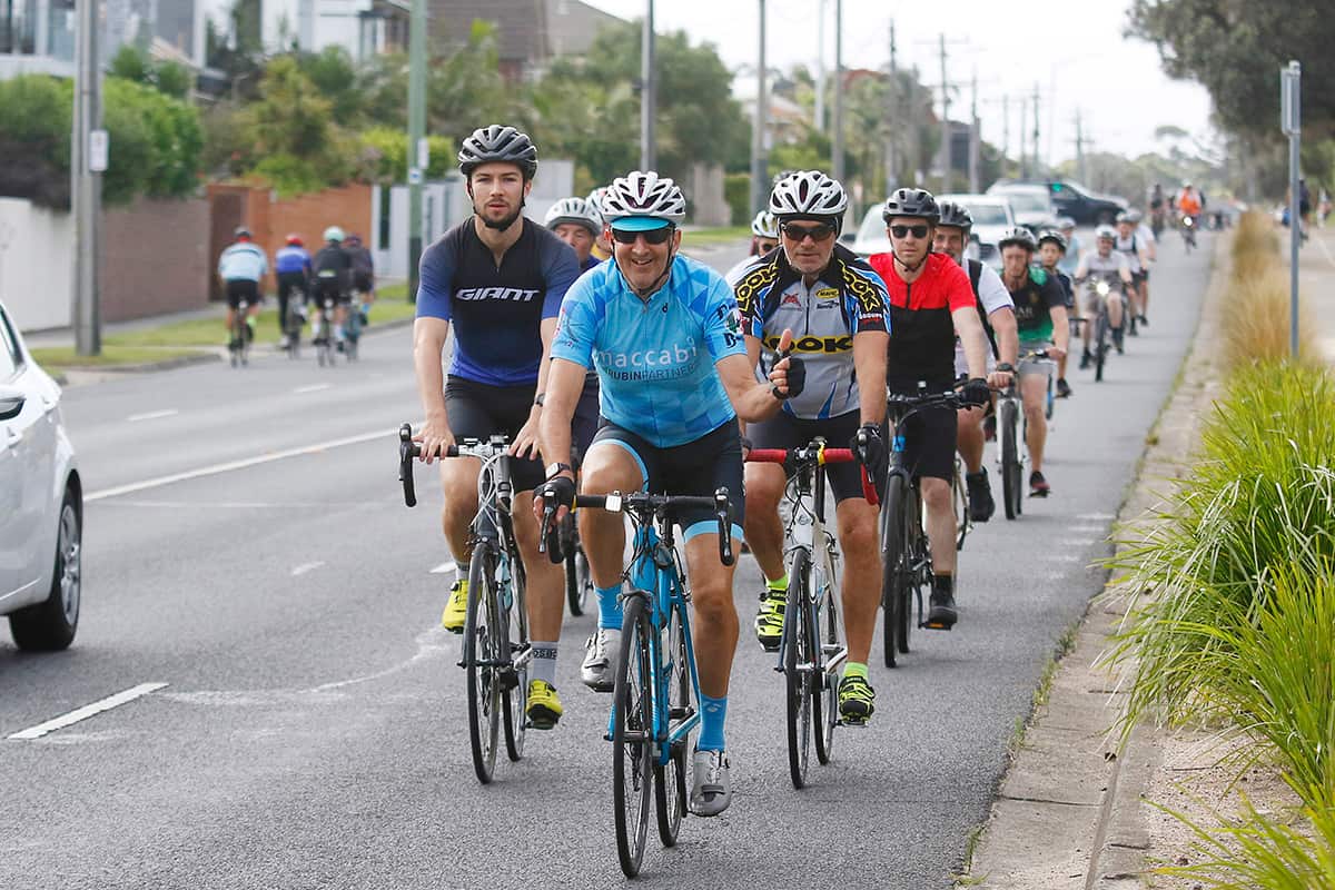 A group of cyclists riding on a street