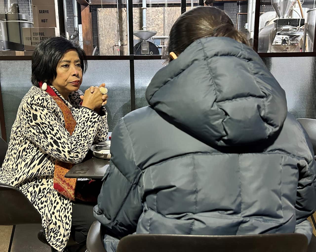 Manorani Guy sitting in a Melbourne cafe with Priyanka.