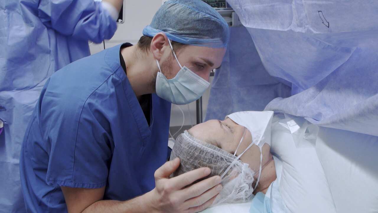 A woman and man in an operating theatre.