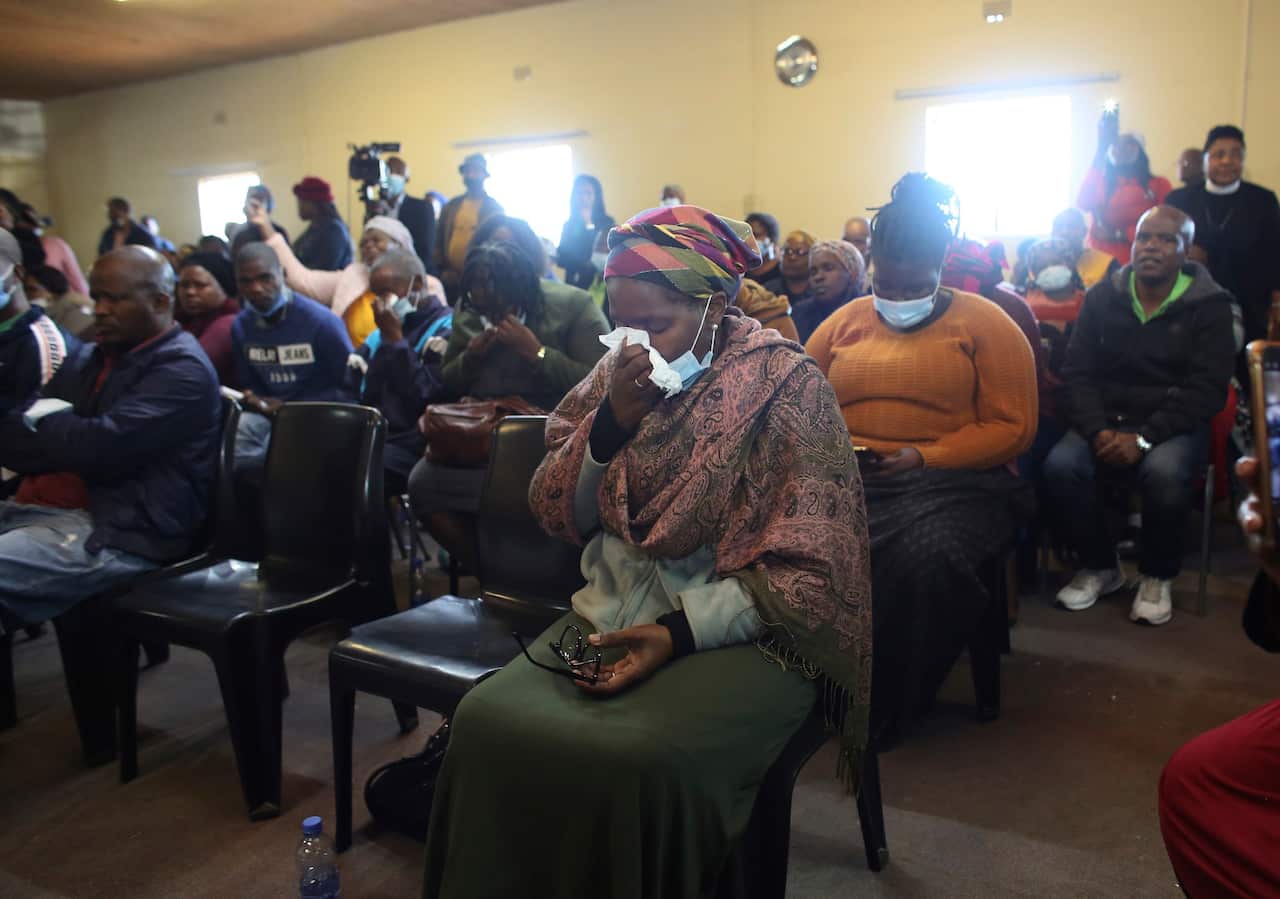 Mourners attend a service at the Assembly of God Church in Scenery Park in East London, South Africa.