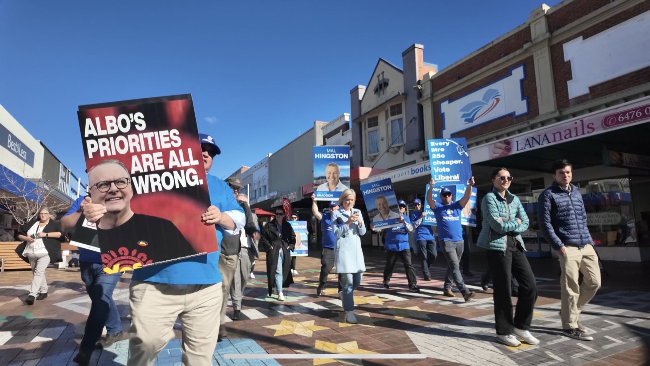 People dressed in blue holding placards. 