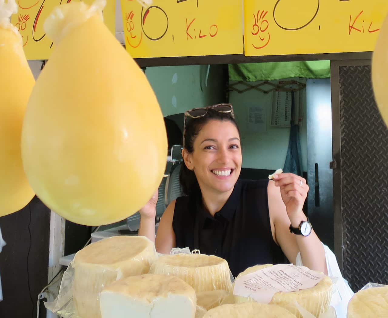 Lisa Ferraro at a cheese stall at the Catania market