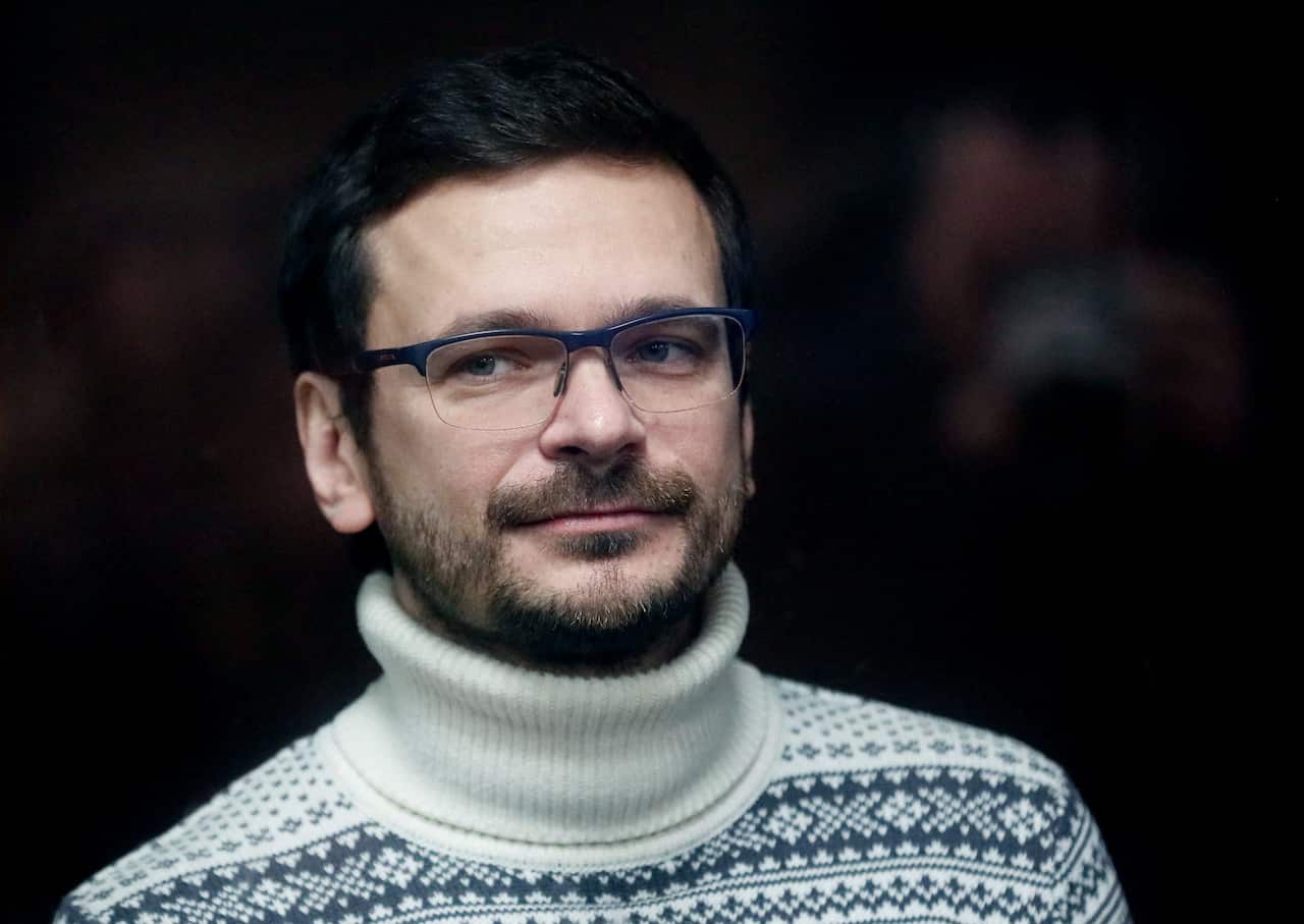 A man wearing a sweater and glasses.