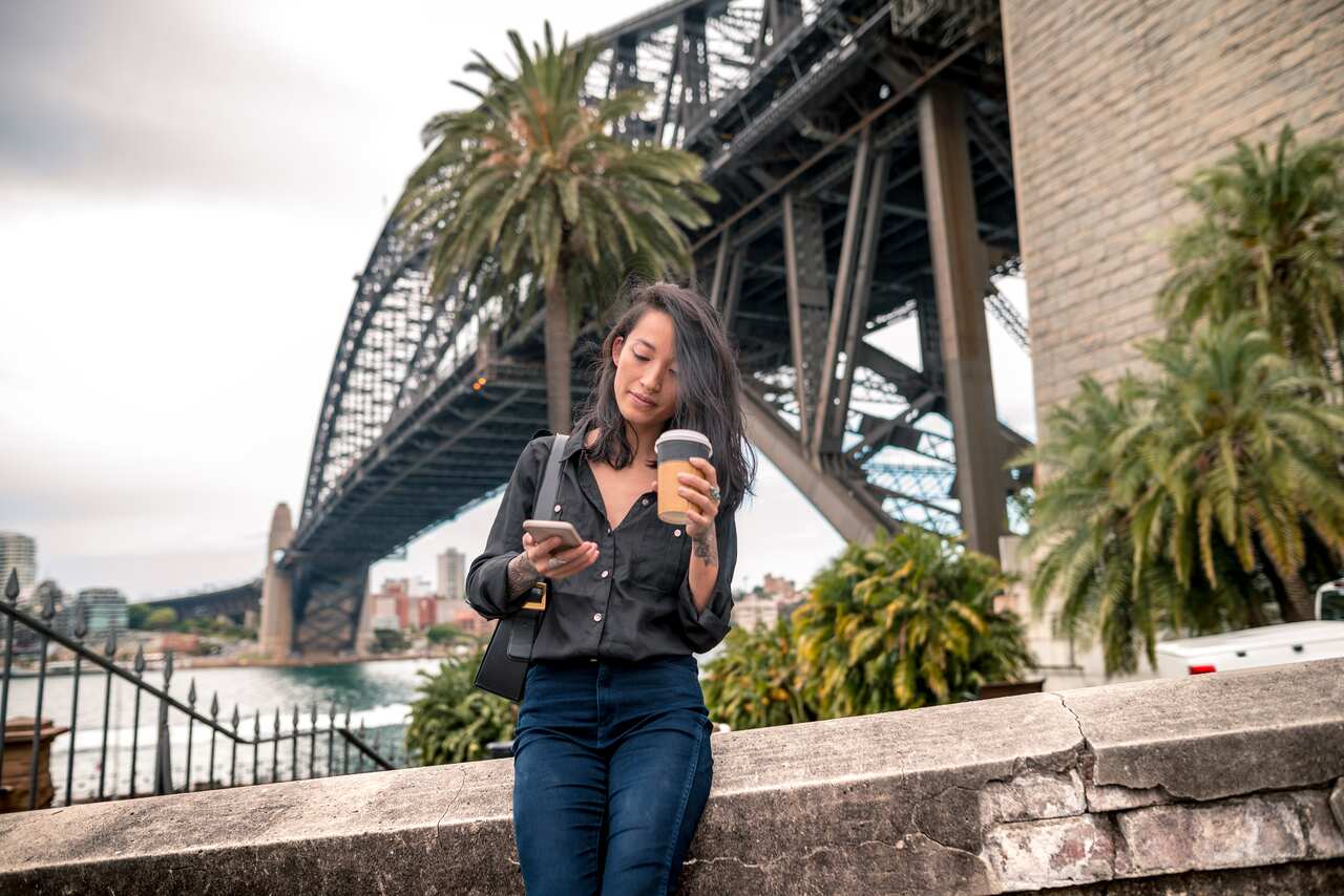 Young adult woman next to Sydney Harbour Bridge
