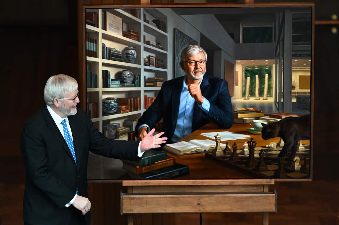 Kevin Rudd points to his portrait.