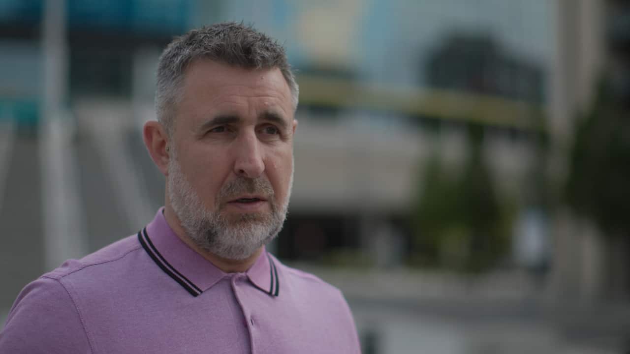 A man wearing a purple shirt.