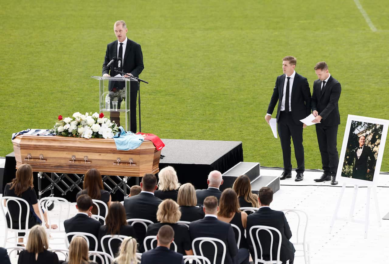 A man delivering a eulogy at a funeral.