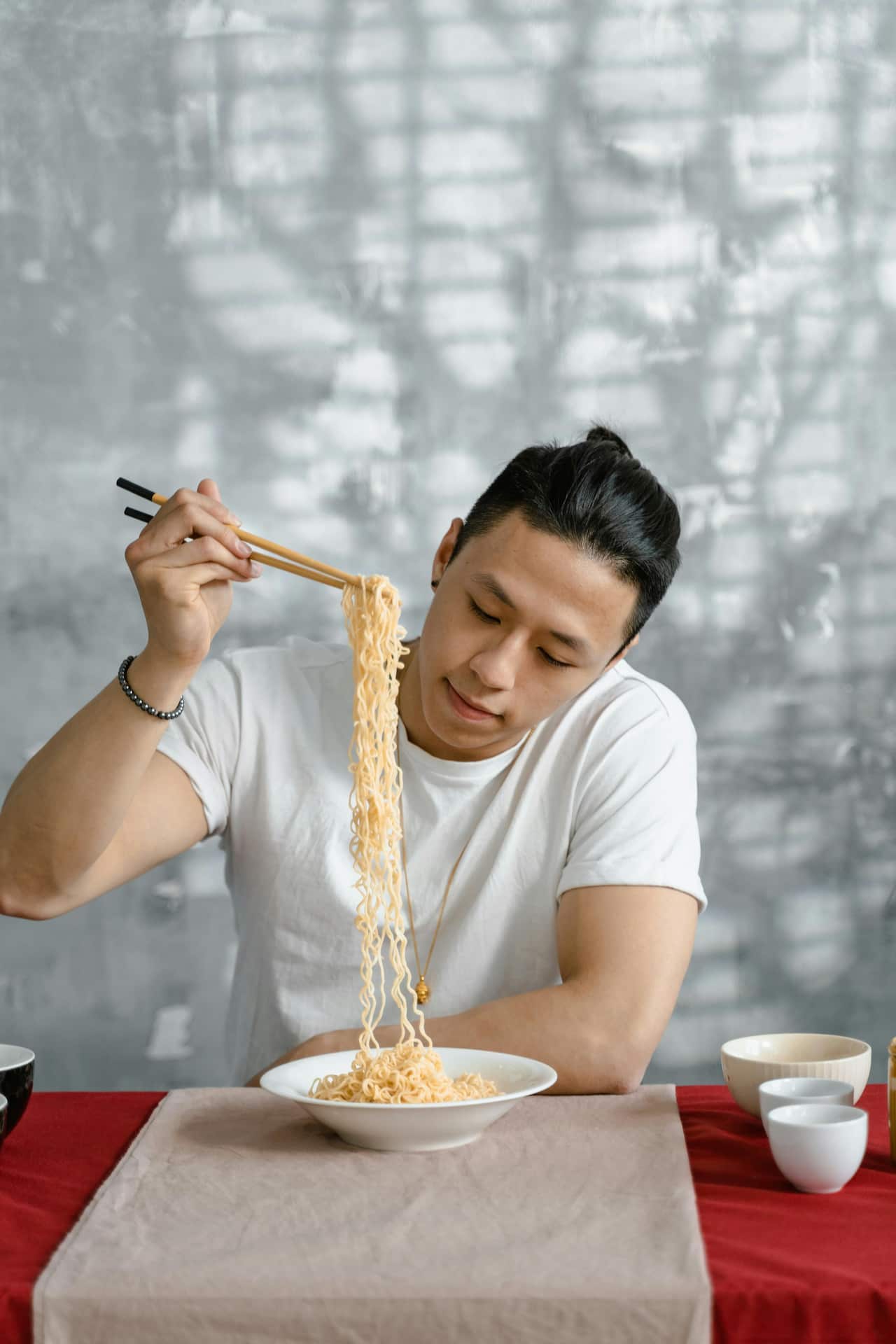 A man eating noodle-pexels-mart-productio.jpg