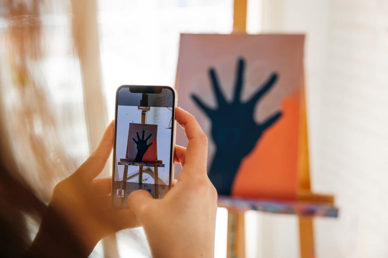 Artist taking a picture of her "work in progress" drawing