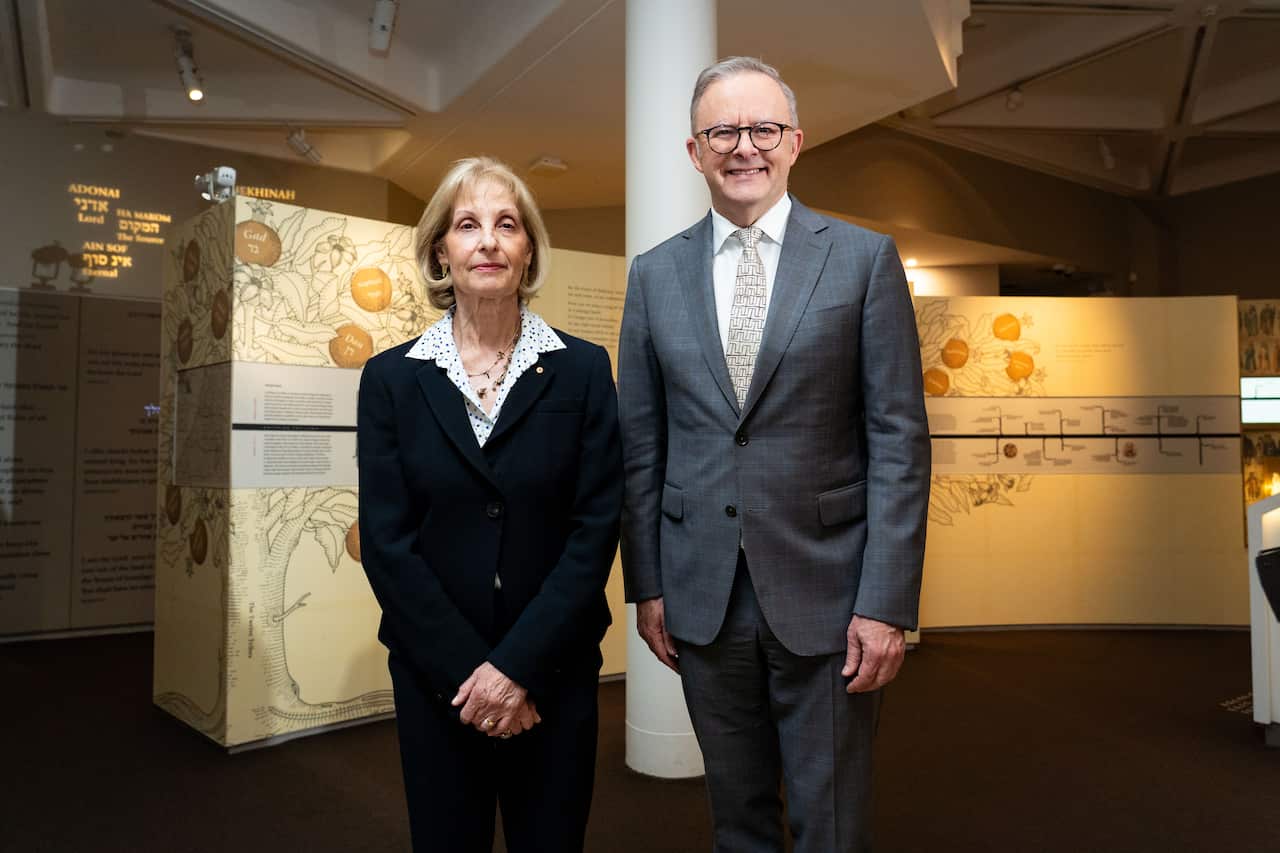 A woman and a man standing for a photo together.