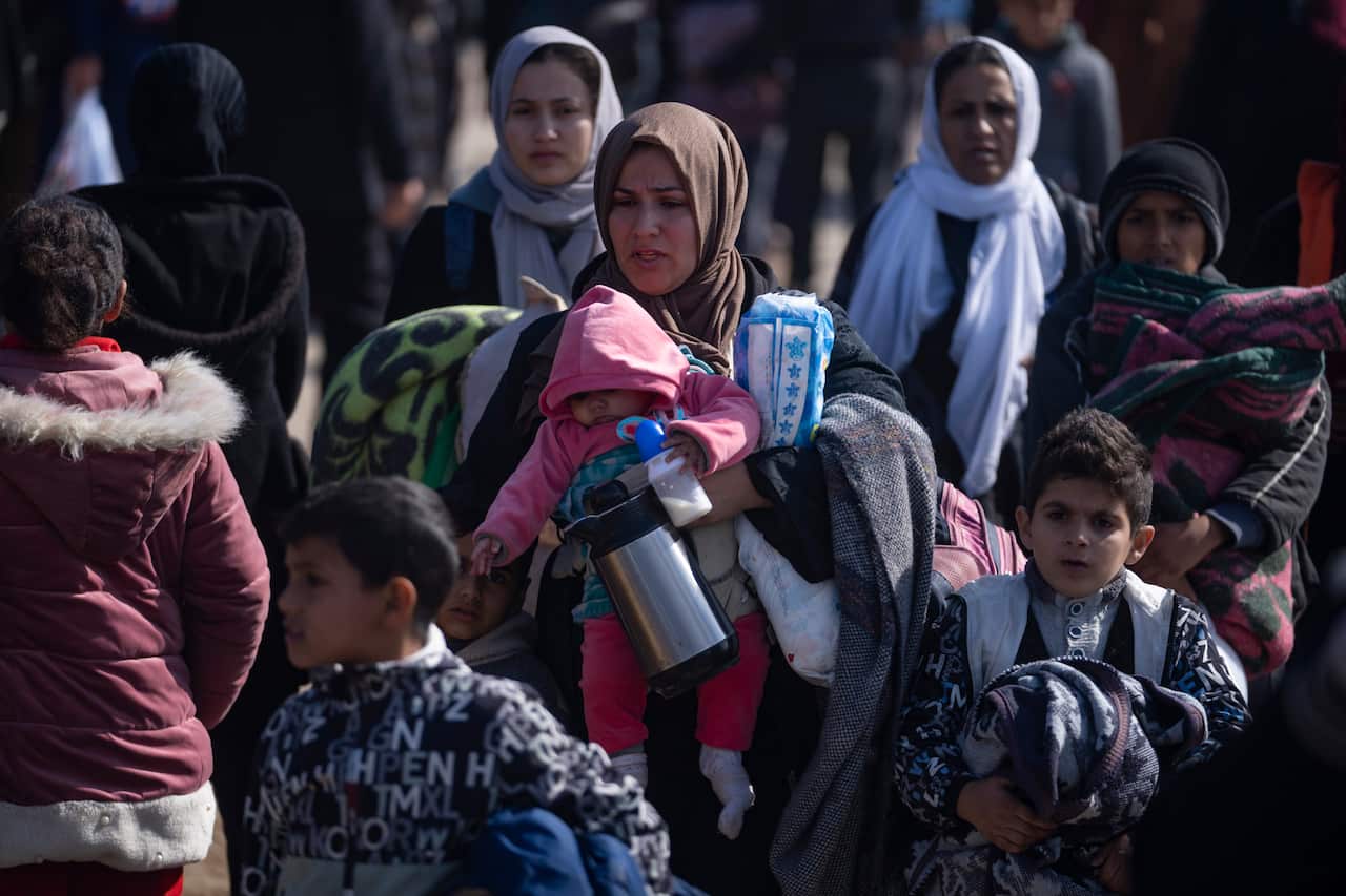 A group of women and children walking.