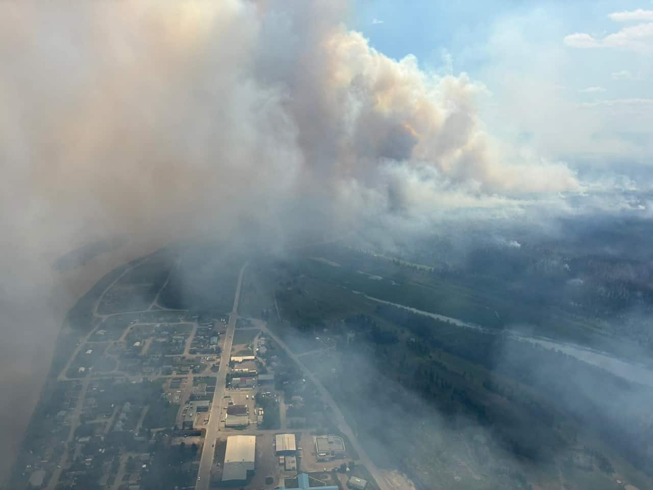 Smoke billows above a township.