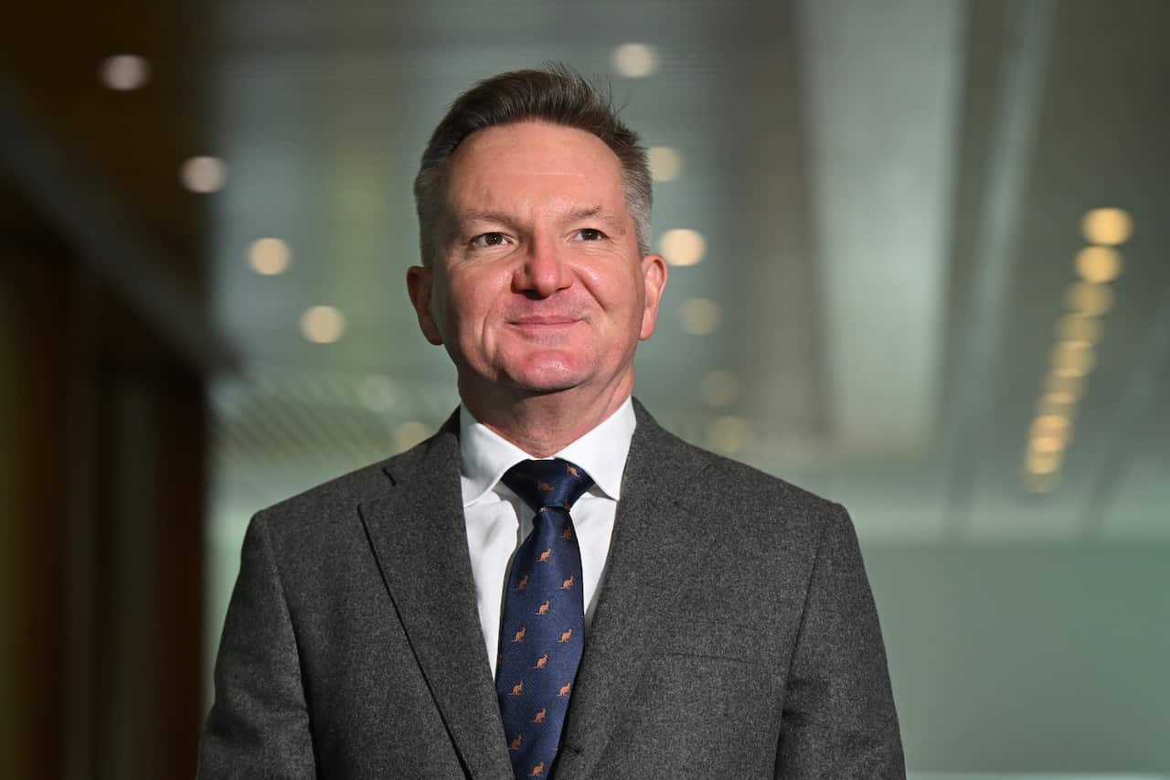 A man in a grey suit and white shirt