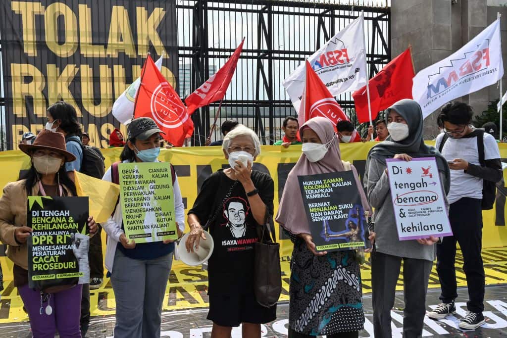 Activists holding a protest against the new criminal code outside the parliament building in Jakarta.