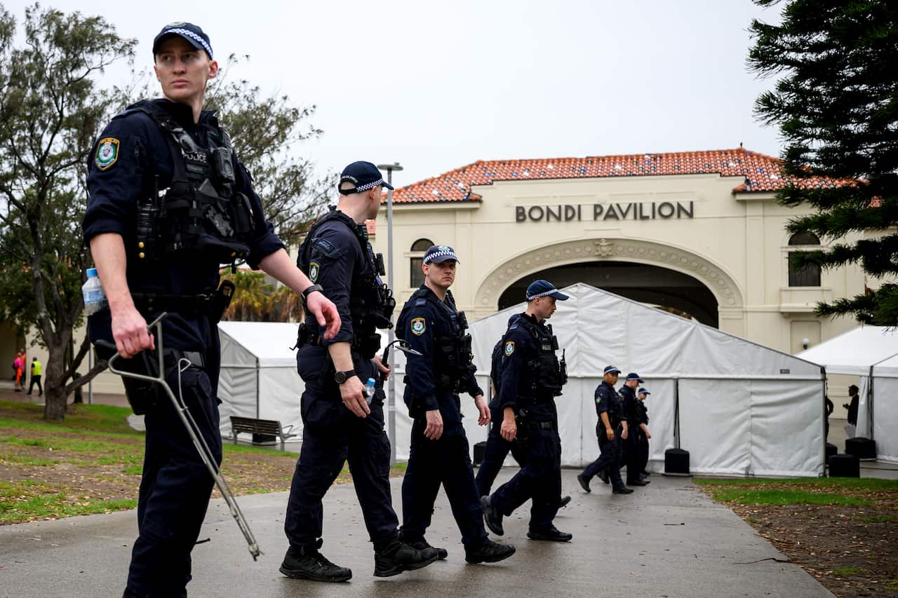 Uniformed police conducting a line search in front of Bondi Pavilion