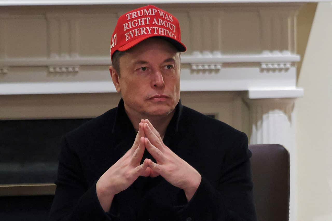 Elon Musk is wearing a red cap that says "Trump was right about everything".