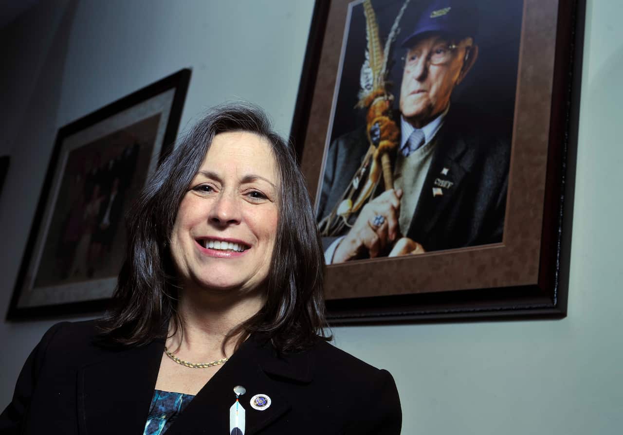 Marilynn "Lynn" Malerba stands next to a photograph of late Chief Ralph Sturges at Tribal offices in Uncasville, Conn/