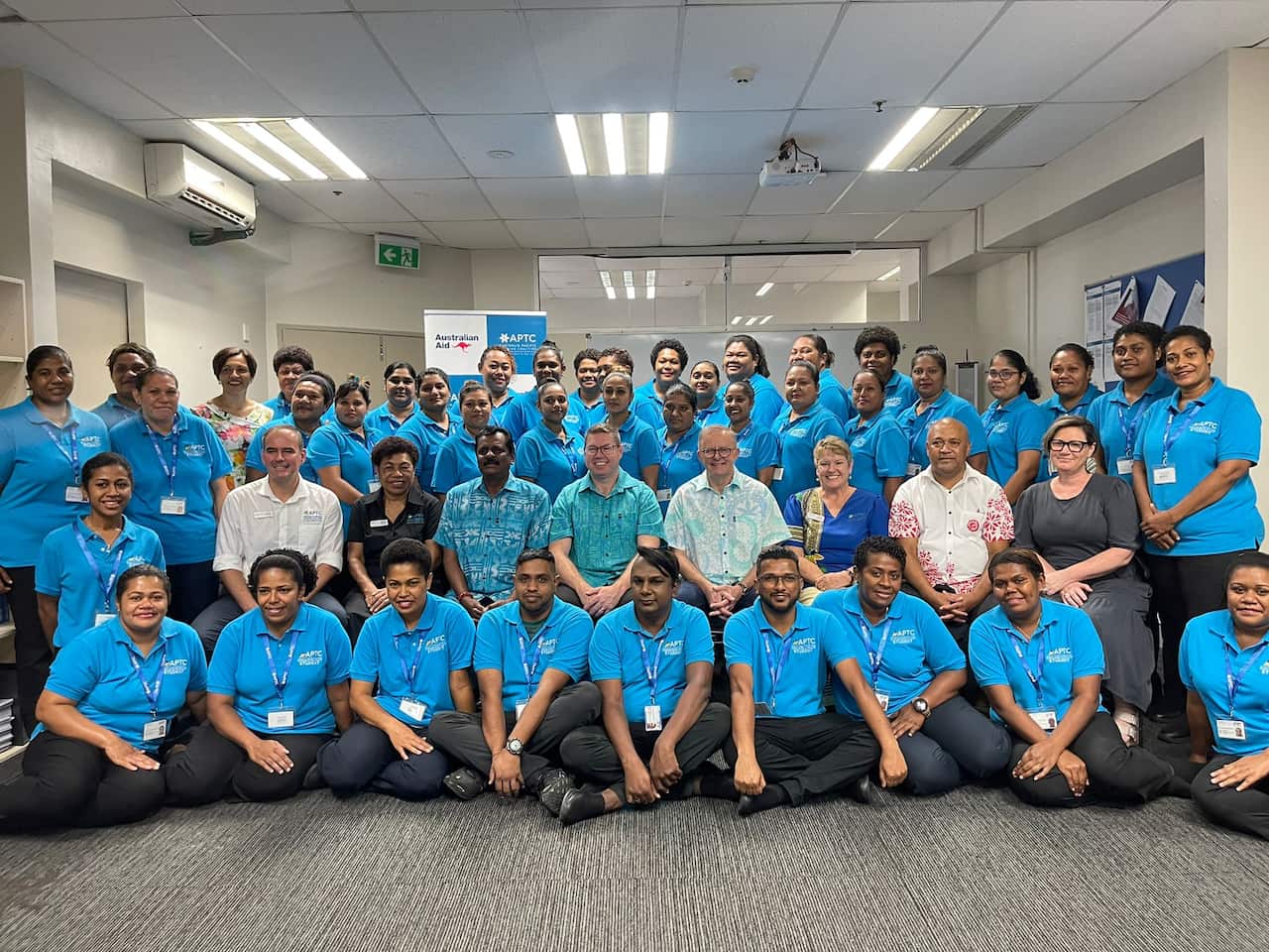 A large group of people inside posing for a photograph 