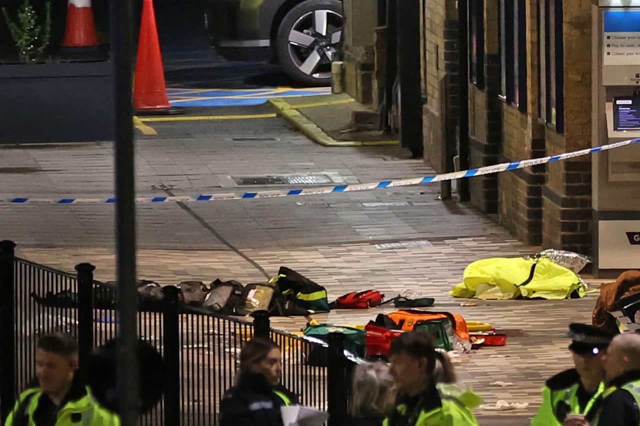 Clothes strewn on the ground behind police tape