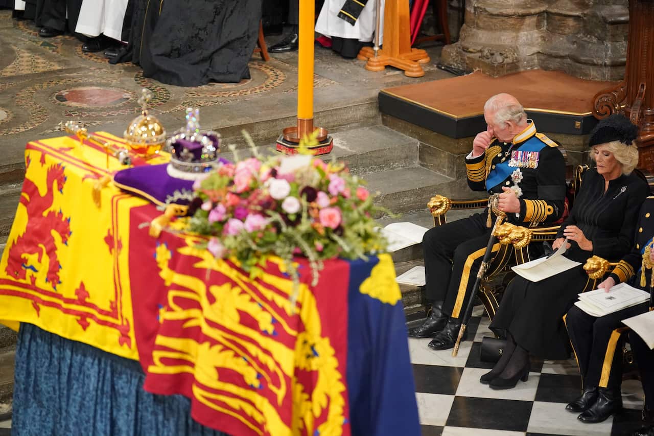 King Charles III and the Queen Consort in front of the coffin of Queen Elizabeth II during her State Funeral at the Abbey in London.