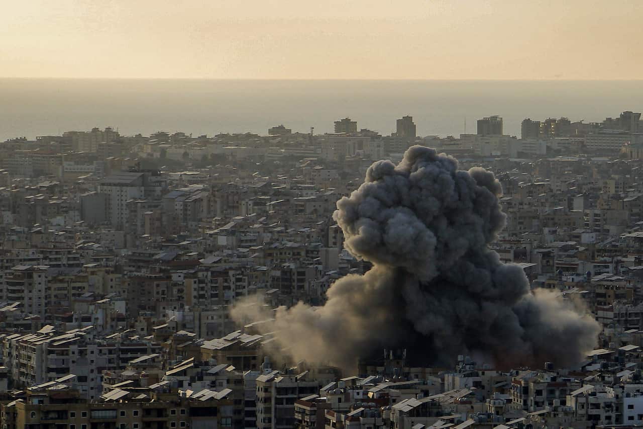 Aerial view of thick black smoke rising from a part of a city