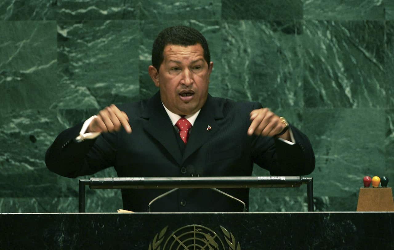 A middle-aged latin american man wearing a black suit
