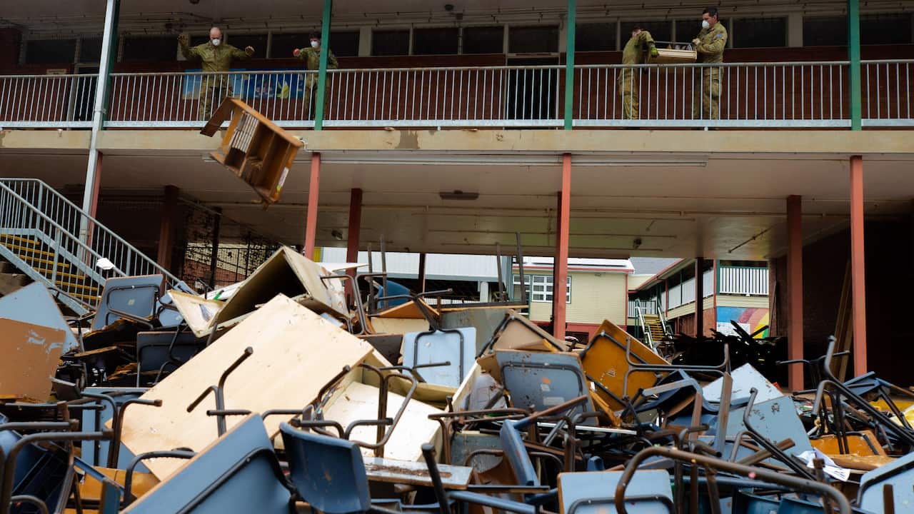 Australian Army troopers of the 1st Armoured Regiment removing flood-damaged equipment and furniture from the Richmond River High School as part of Operation Flood Assist 2022.
