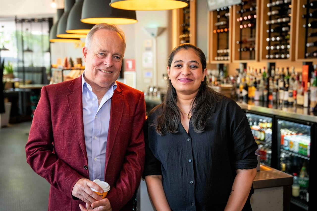 Song Hotel general manager Jon Ackary (left) with YWCA's Pooja (SBS).jpg