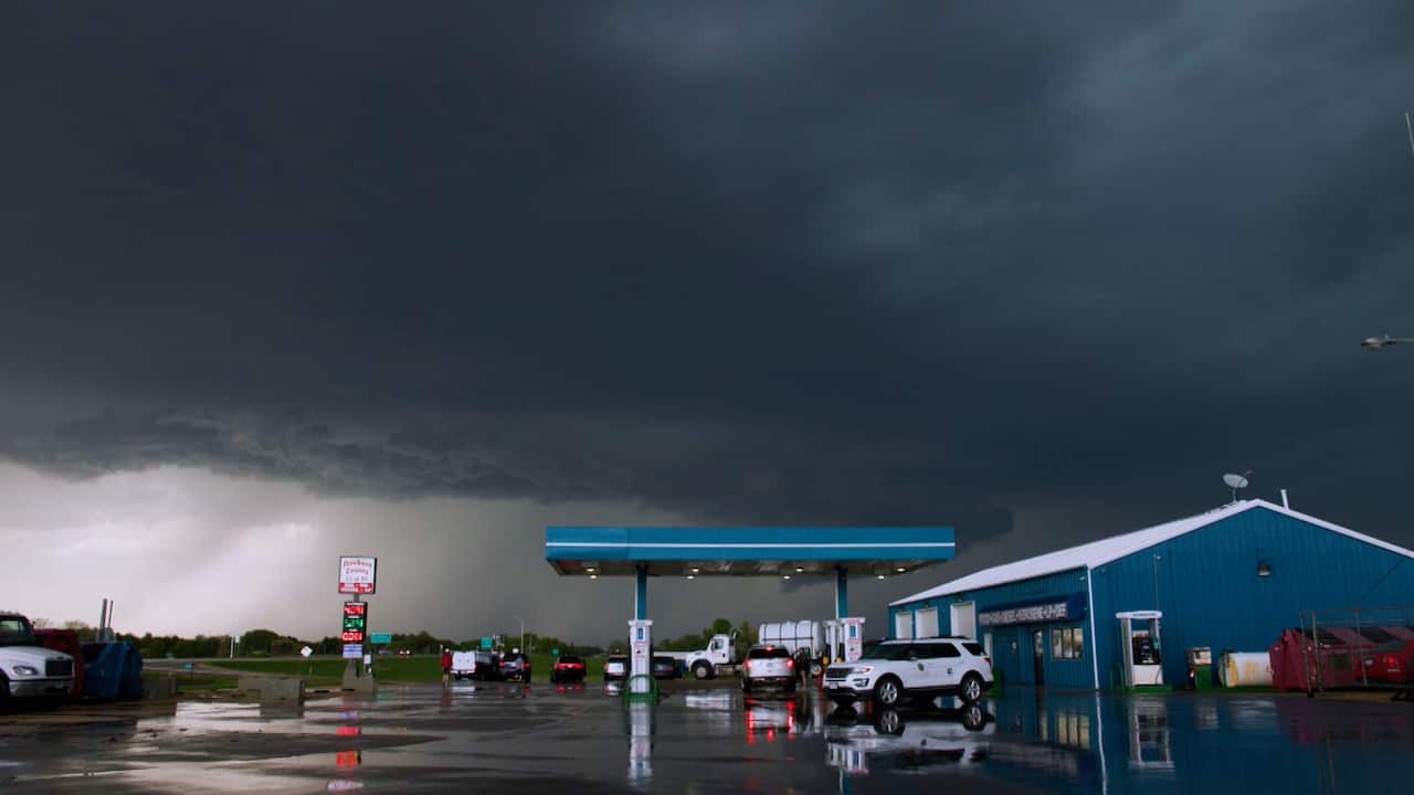 A petrol station with a storm cloud brewing overhead.