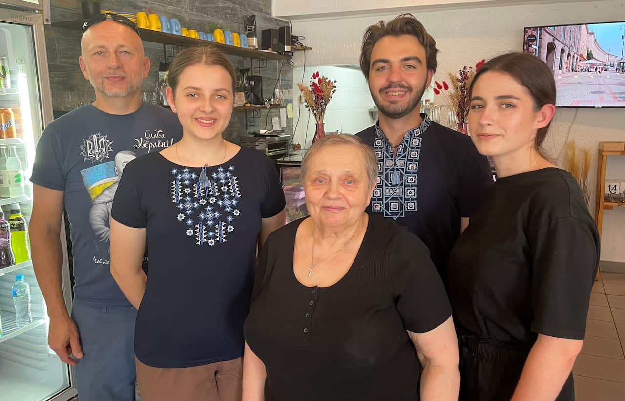 Five people standing together inside