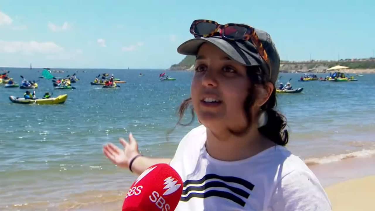 A woman speaking to a journalist