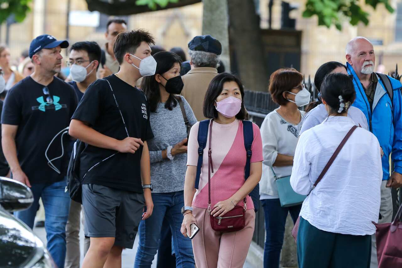 Tourists wearing face masks as a precaution against the spread of COVID-19 in central London. 
