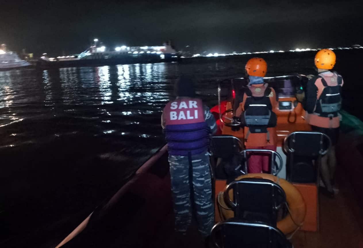 Rescuers on a ferry in the water.