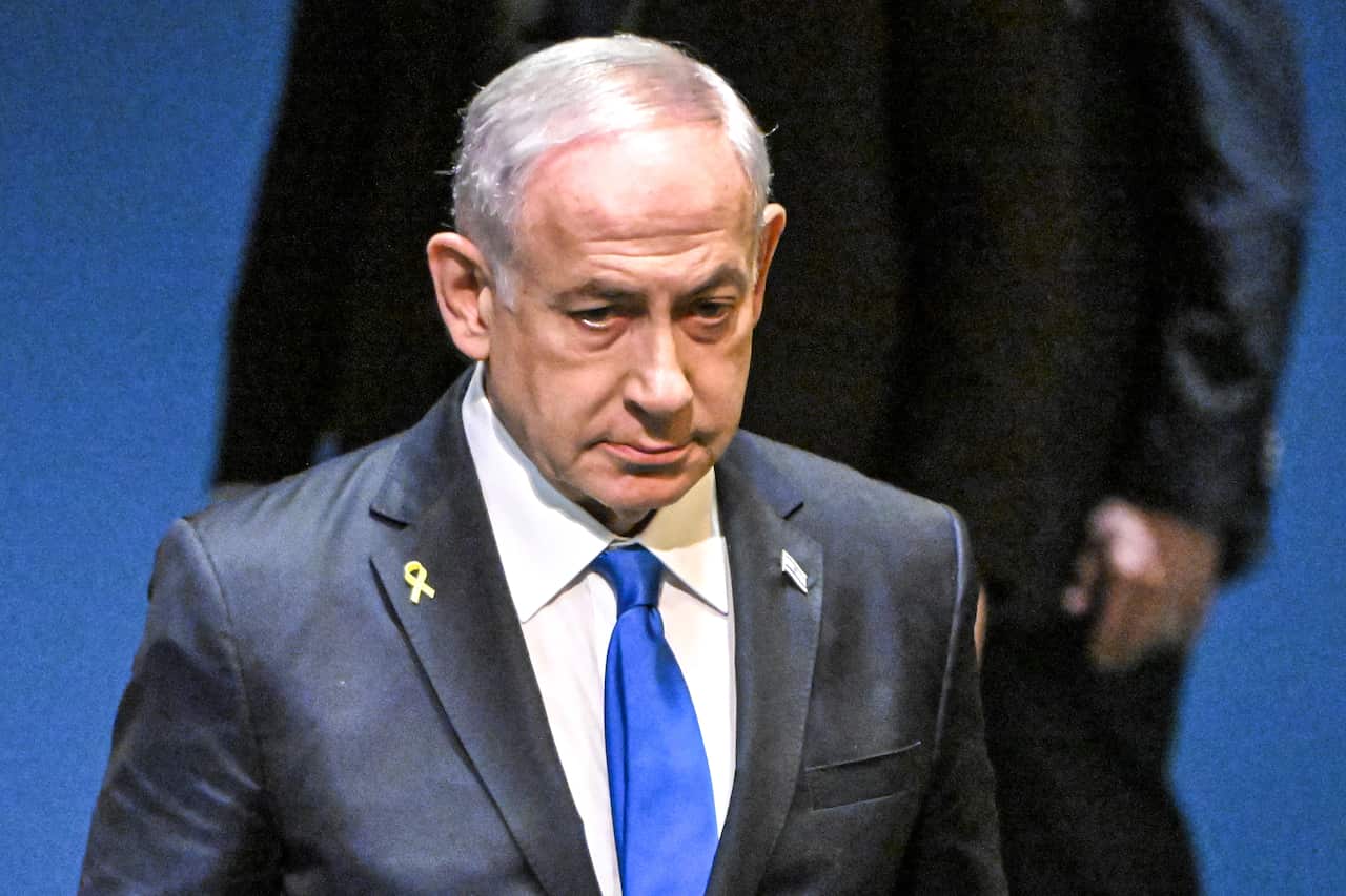 Benjamin Netanyahu wearing a grey suit and blue tie