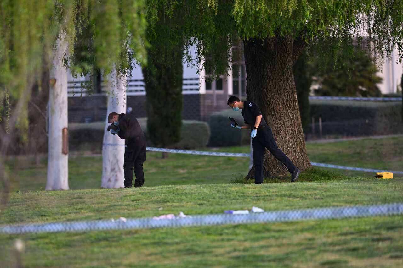 Police forensics officers work at a crime scene 